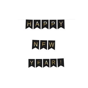 Gold foil Happy New Year banner on black cardstock for festive party decoration