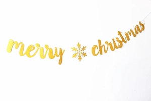 Detailed view of Merry Christmas banner featuring gold glitter letters and snowflake