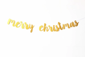 Close-up of golden glitter Merry Christmas banner with elegant cursive script lettering
