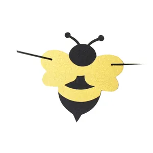 Glittery bumblebee party banner decoration with gold wings for first birthday party