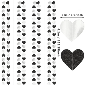 Close-up of heart-shaped glitter garlands in black and silver for party decoration