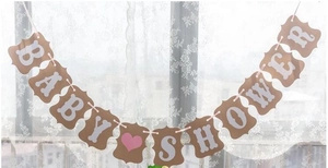Detail of vintage kraft paper Baby Shower banner with pink heart on white lace background
