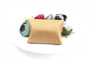 Detailed view of an eco-friendly brown kraft paper pillow box for wedding gift packaging
