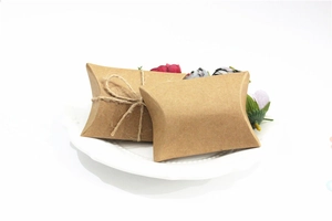 Detail of vintage kraft paper pillow boxes with twine for elegant wedding favors