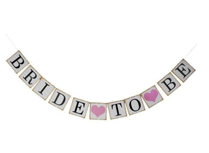 Detail of Bride To Be paper banner with black letters and pink hearts for bridal showers