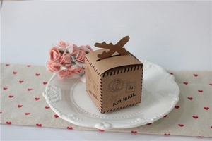 Close-up of kraft paper air mail gift box with unique airplane-shaped closure design