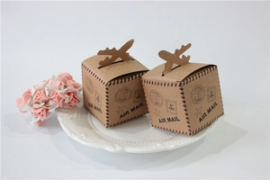 Detail of kraft paper wedding favor boxes with vintage air mail theme and red blue stripes