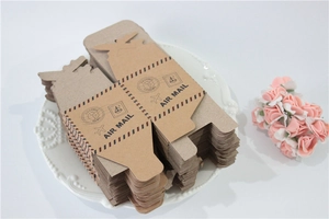 Flat kraft paper pillow boxes with air mail stamp design on a white decorative plate