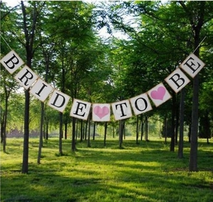 Bride to Be paper banner with gold edges and pink hearts for bridal shower decoration