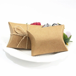 Kraft paper pillow gift box with hemp rope twine on a decorative ceramic tray