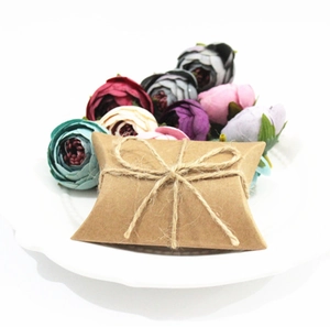 European kraft paper pillow gift box with twine bow knot on elegant floral display
