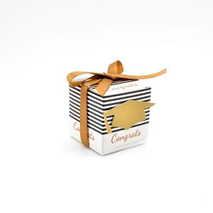 Detail of graduation gift box with black stripes, gold ribbon and Congrats text