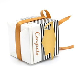 Elegant white striped graduation gift box with Congrats text and golden cap ornament