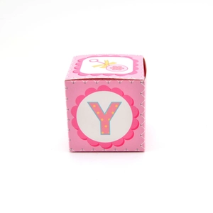 Pink square baby shower candy gift box with letter Y and yellow bow on white background