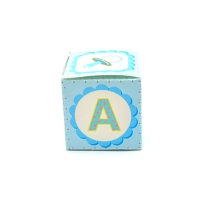 Close-up of a blue baby shower favor box featuring a pink letter A and pacifier icon