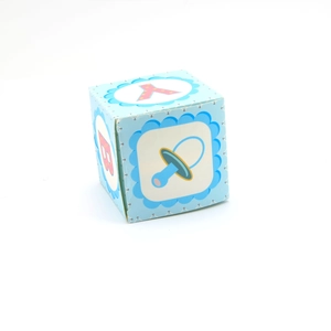 Detailed view of blue square baby shower gift box featuring letters and pacifier motifs