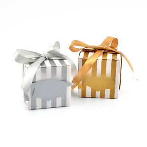 Detail of graduation gift boxes with gold and silver stripes, ribbons and mortarboard tags