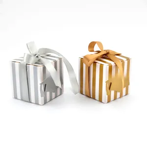 Detail of graduation gift boxes with striped patterns and doctor hat tags in silver and gold