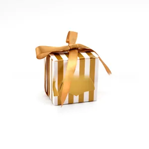 Detail of graduation candy box with gold ribbon and mortarboard cap decoration