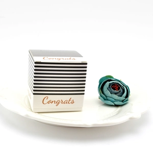 Detail of square black and white striped gift box with Congrats text and floral decor