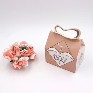 Detail of house-shaped champagne wedding favor box with bride dress illustration