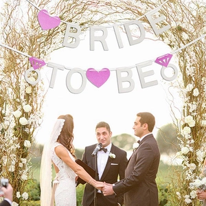 Glittery Bride to Be banner with pink hearts and diamond ring decorations for weddings