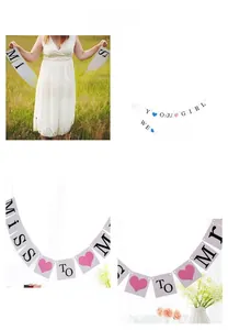 Close-up of Miss to Mrs party banner cards with heart accents and string for wedding decor