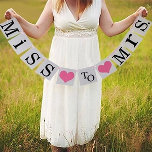 Outdoor MISS TO MRS wedding banner with white cardstock and pink ribbon for bridal party