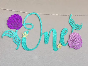 Close-up of One mermaid glitter banner with shells and starfish for 1st birthday decor