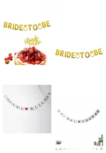 Close-up of golden glitter Bride to Be banner and matching cake topper for bridal showers