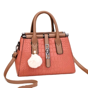 Coral pink crocodile embossed tote bag with khaki handles and soft plush charm
