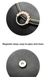 Detail of leather tote with golden ring, white pearls, and secure magnetic buckle closure