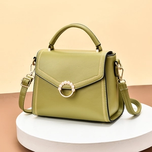 Grass green leather tote bag with pearl metal ring and elegant V-shaped stitching