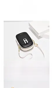 Detailed top view of a black and white crossbody bag with polished silver metal buckle