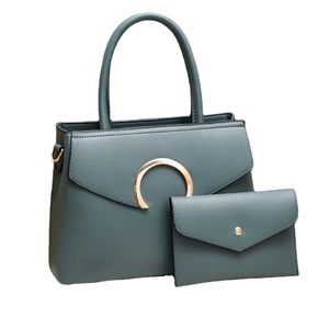 Deep teal leather handbag set with gold buckle and matching envelope clutch bag