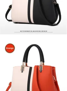 Close-up of contrast color patchwork leather handbags in orange and black with pebble grain