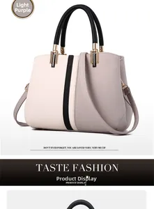 Detail of tricolor paneled leather handbag in light purple, pink and black with gold hardware
