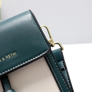 Detail of the high-quality stitching and gold-tone metal hardware on the mini crossbody bag