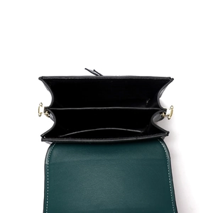Deep green leather mini crossbody bag with three interior compartments and contrast stitching
