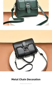 Detailed view of women's leather handbag featuring metal chain decor and U-shaped buckle