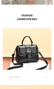 Detail of black chic shoulder bag with metallic clasp and decorative chain accent