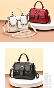 Detail view of stylish crossbody bags with metal buckle and decorative chain trim