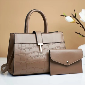 Detail view of brown PU leather handbag set with croc-embossed texture and T-shaped metal buckle