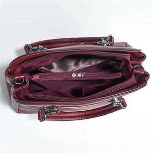 Top view of deep red tote bag showing interior compartments and purple satin lining