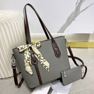 Detail view of large grey pebbled leather tote bag with silk scarf and matching purse
