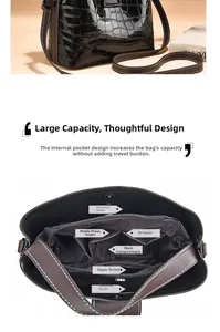 Detail view of the interior compartments and glossy crocodile pattern bucket bag