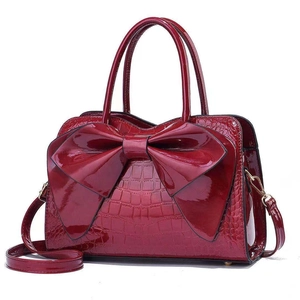 Elegant wine red crocodile pattern handbag with large bow and crossbody strap