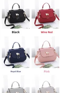 Litchi texture leather handbags with golden cat-shaped clasps and tassel details