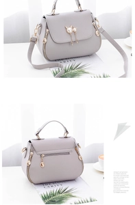 Detail of lavender litchi pattern leather bag with pearl cat tassel and gold hardware
