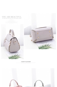 Detail view of light purple leather bag featuring gold hardware and bottom metal studs